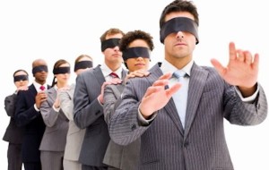 Image of a row of blindfolded business people standing with their hands on the shoulders of the person in front