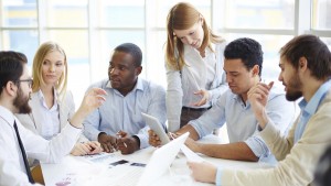 Group of confident business partners interacting at meeting